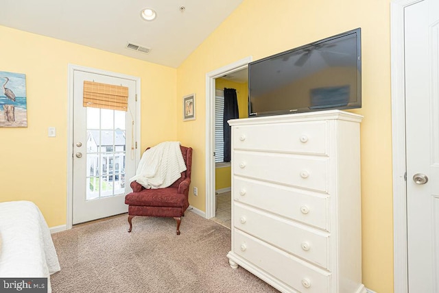 living area featuring lofted ceiling and light colored carpet