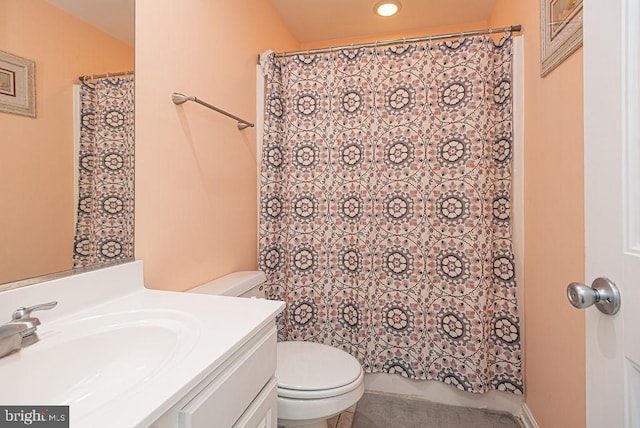 bathroom featuring vanity, toilet, and curtained shower