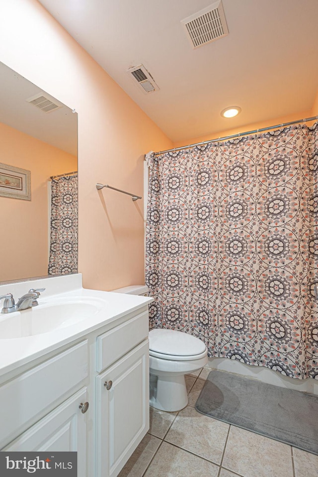 bathroom featuring vanity, toilet, and tile patterned floors