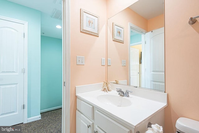 bathroom with vanity and toilet