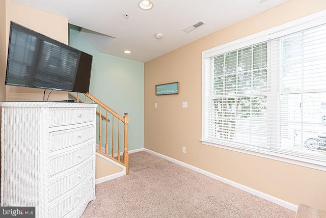 unfurnished living room with light colored carpet