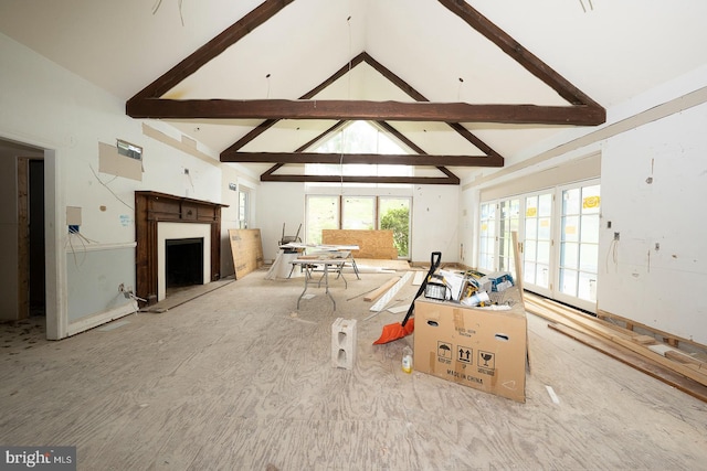 living room featuring a fireplace, high vaulted ceiling, and beamed ceiling