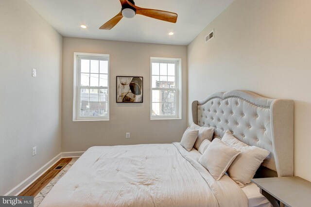 bedroom with ceiling fan and hardwood / wood-style floors