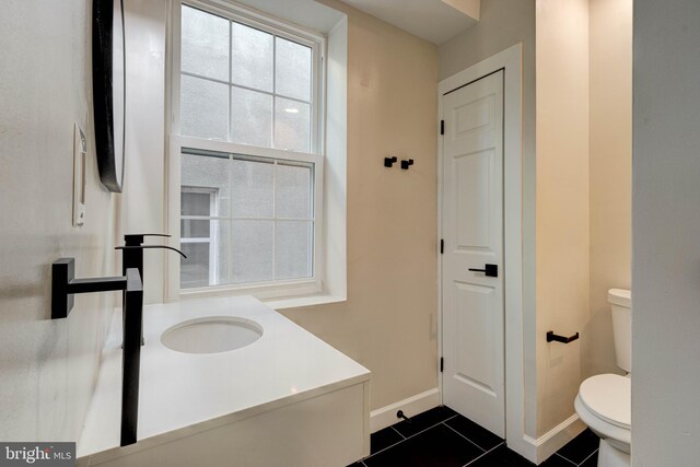 bathroom with tile patterned flooring, toilet, and vanity