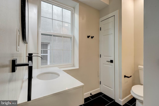 bathroom with vanity, toilet, and tile patterned floors