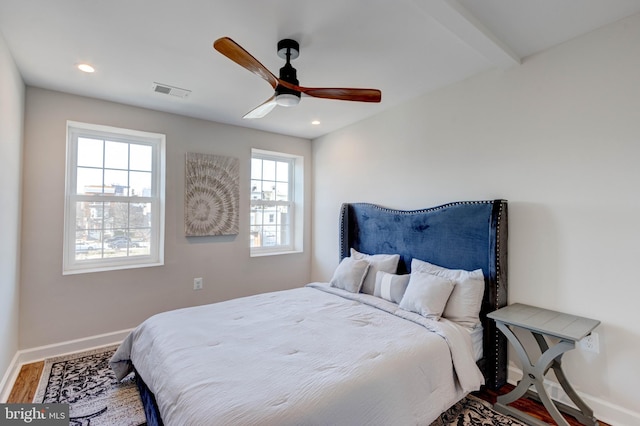 bedroom with hardwood / wood-style floors, ceiling fan, and beamed ceiling