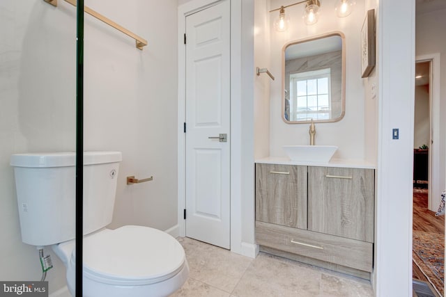 bathroom with tile patterned flooring, toilet, and vanity