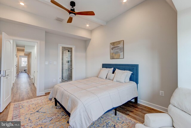 bedroom with light wood-type flooring, ceiling fan, ensuite bathroom, and lofted ceiling