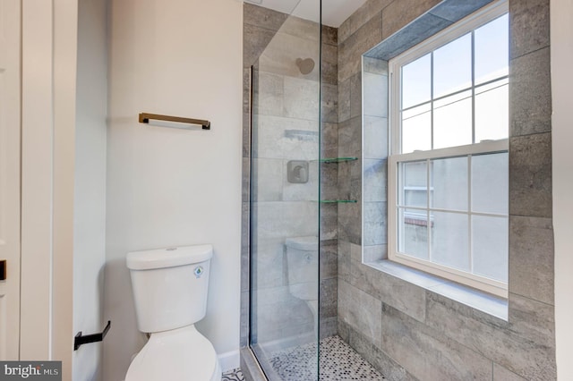 bathroom with toilet and an enclosed shower