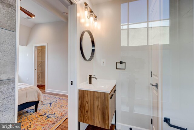 bathroom featuring an enclosed shower, vaulted ceiling, vanity, and hardwood / wood-style floors