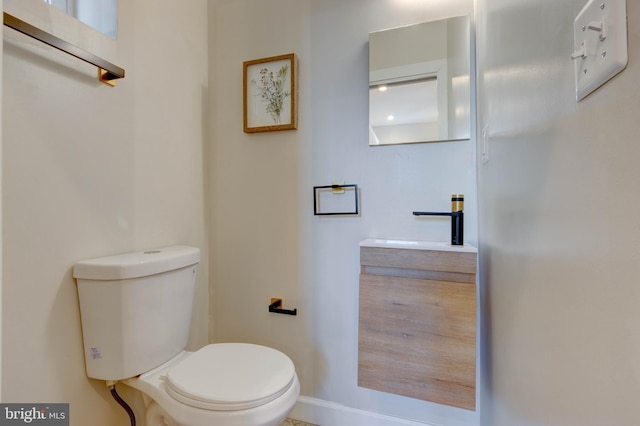 bathroom featuring toilet and vanity