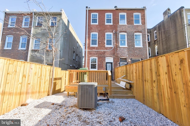 back of house with central AC and a deck