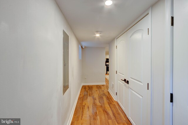 corridor with light hardwood / wood-style floors