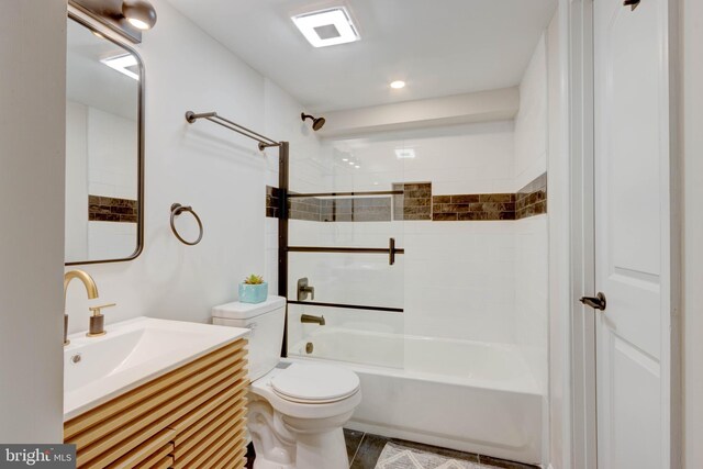 full bathroom with tiled shower / bath combo, toilet, and vanity