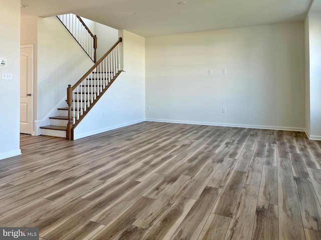 13810 Pulaski Dr Unit 72, Hagerstown, MD 21742 - unfurnished living room with wood finished floors, stairway, and baseboards