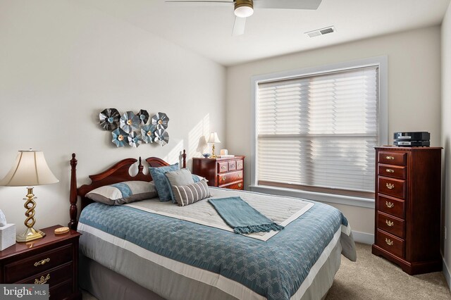 bedroom featuring light carpet and ceiling fan