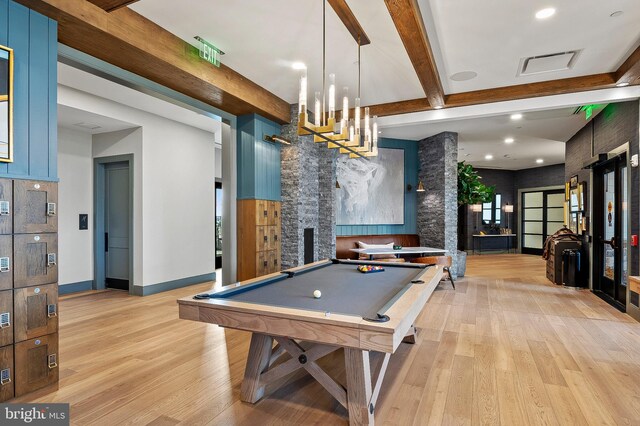 playroom with light wood-type flooring, billiards, a fireplace, and beam ceiling