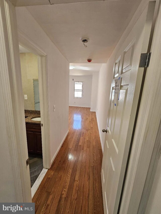 hallway featuring hardwood / wood-style flooring