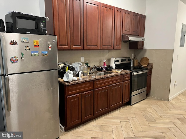 kitchen with sink, dark stone counters, appliances with stainless steel finishes, electric panel, and light parquet flooring