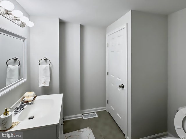 bathroom featuring vanity and toilet