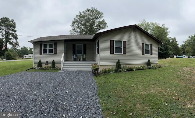 view of front facade featuring a front lawn, a porch, driveway, and crawl space