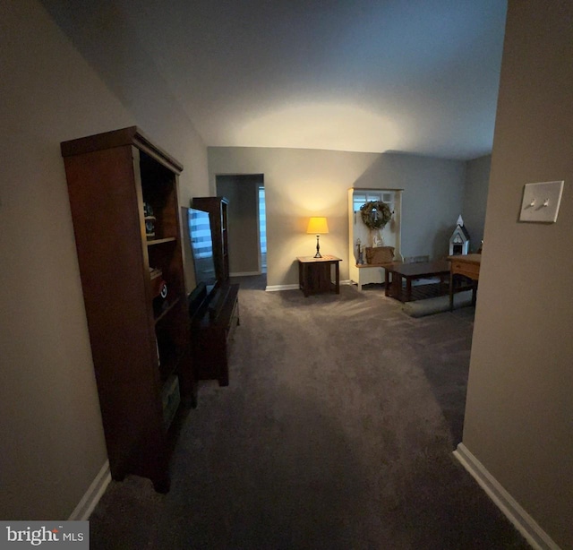 carpeted living room featuring baseboards