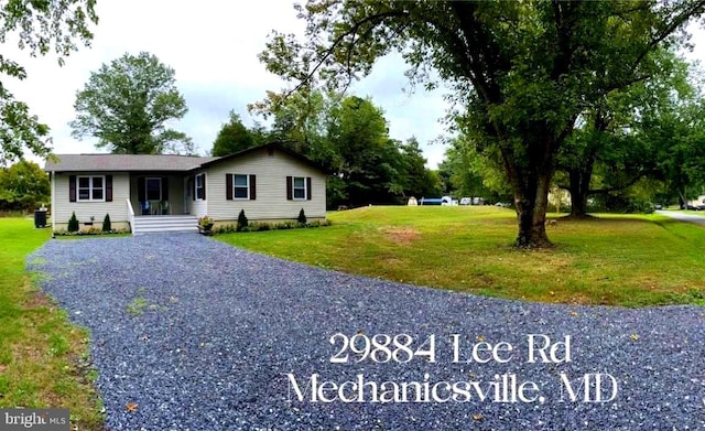 single story home with crawl space, gravel driveway, and a front yard