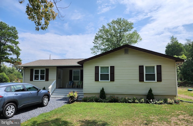 view of front of house featuring covered porch and a front lawn