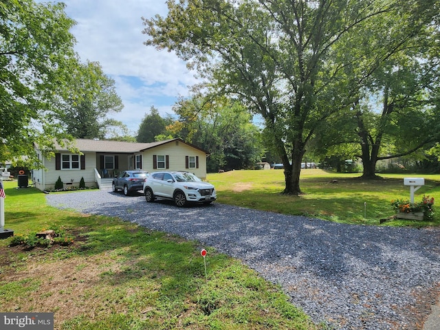 view of front of house with a front yard, driveway, and crawl space