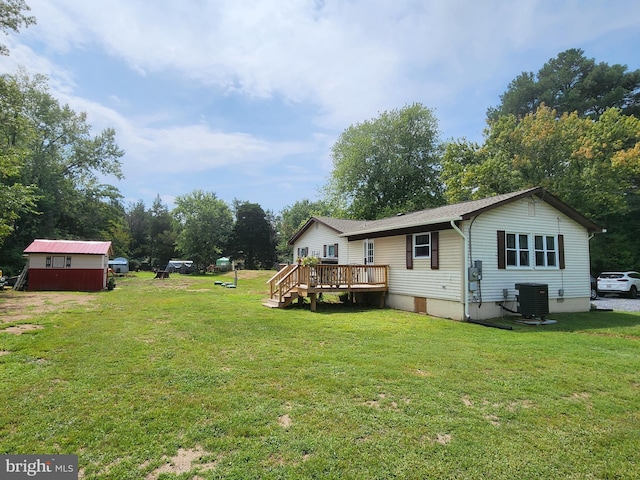 exterior space with a wooden deck, central AC, a lawn, an outdoor structure, and crawl space