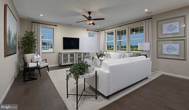 living room with dark hardwood / wood-style floors and ceiling fan