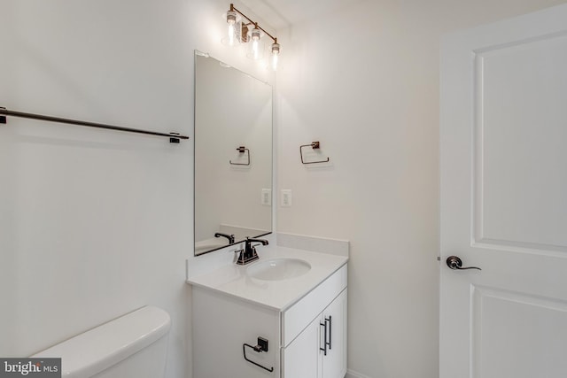 bathroom featuring toilet and vanity