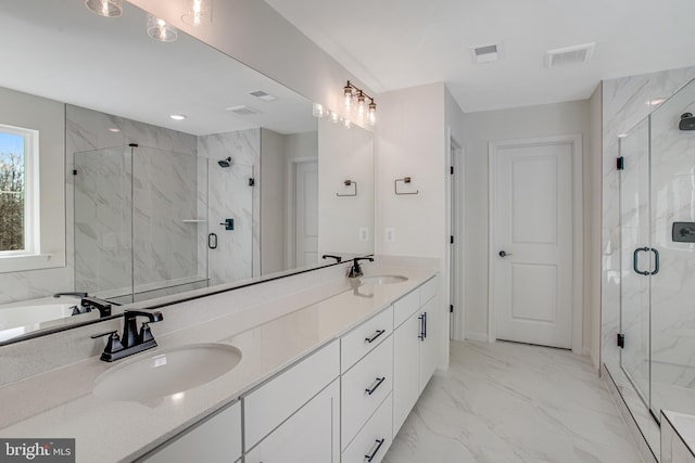 full bath featuring marble finish floor, visible vents, and a sink