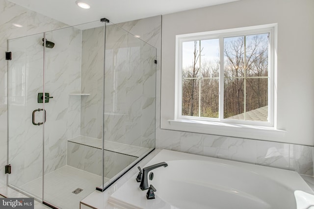 full bath featuring plenty of natural light, a garden tub, a marble finish shower, and recessed lighting