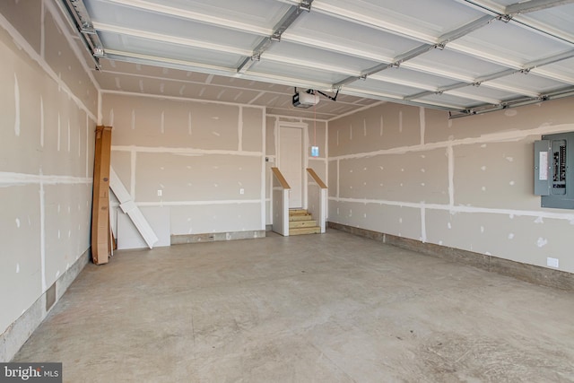 garage with electric panel and a garage door opener