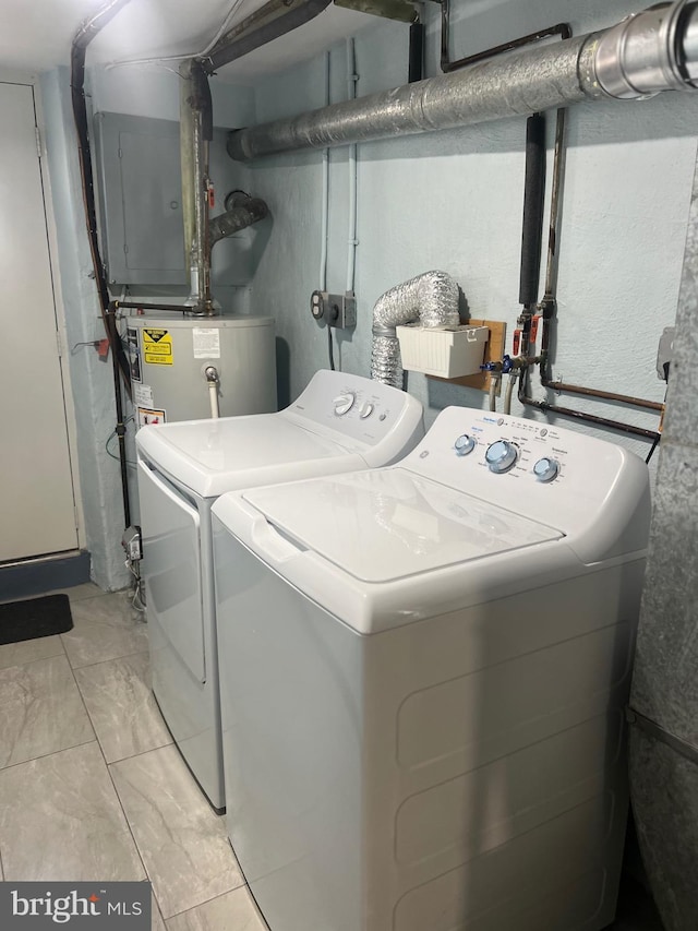 clothes washing area featuring water heater, independent washer and dryer, and light tile patterned floors