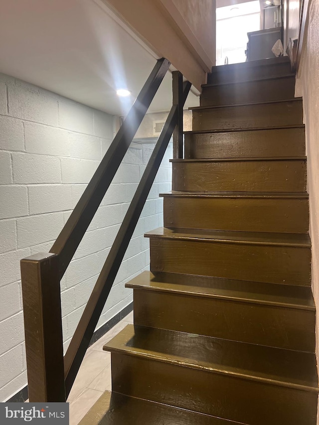 staircase featuring tile patterned floors