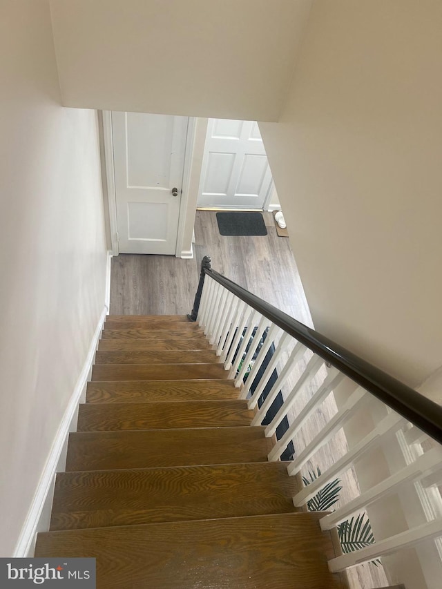 staircase featuring hardwood / wood-style floors