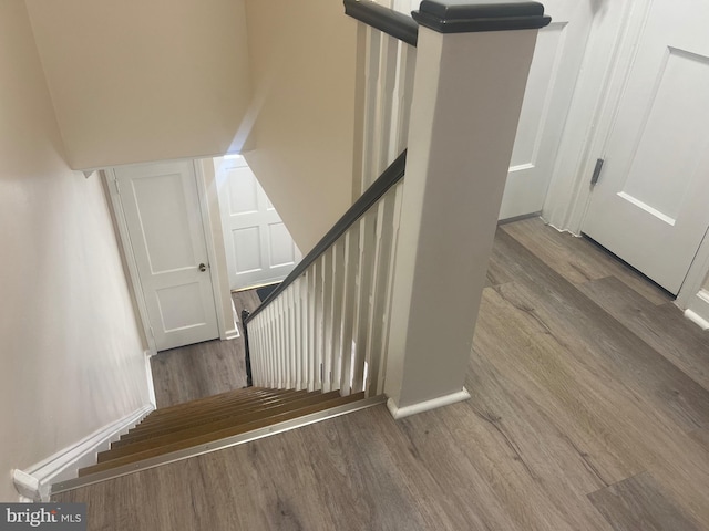 stairs featuring hardwood / wood-style flooring