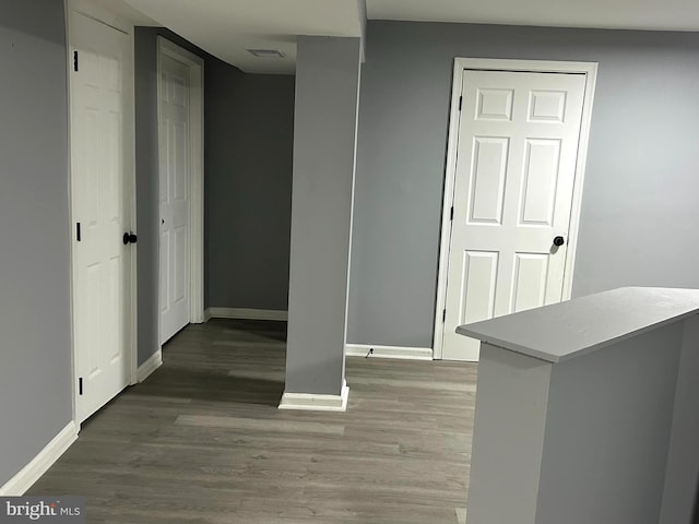 corridor with dark hardwood / wood-style flooring