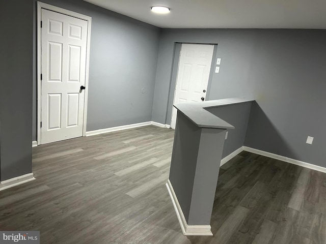 foyer entrance with lofted ceiling and dark hardwood / wood-style floors