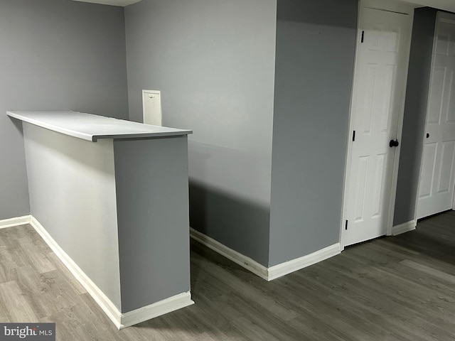 bar featuring dark hardwood / wood-style flooring