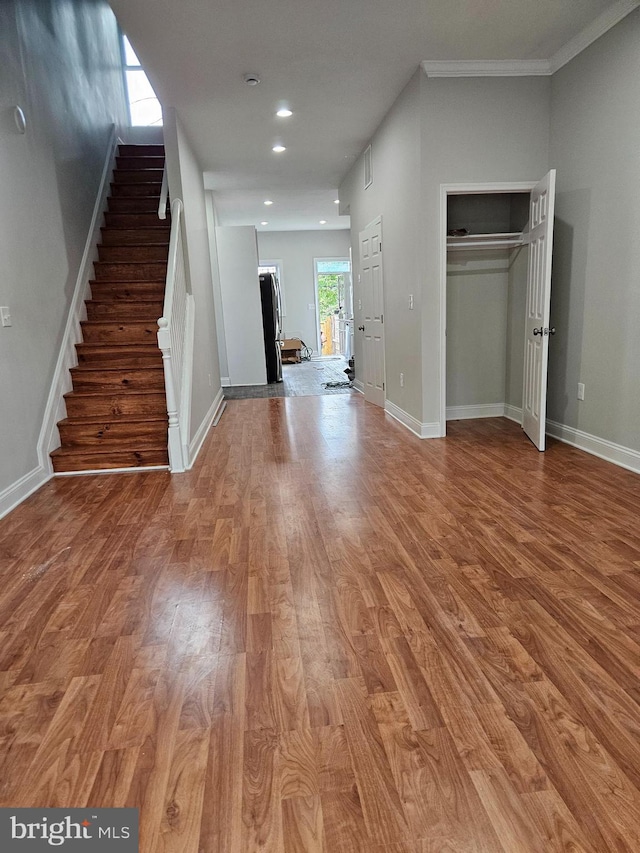 interior space featuring crown molding and hardwood / wood-style floors