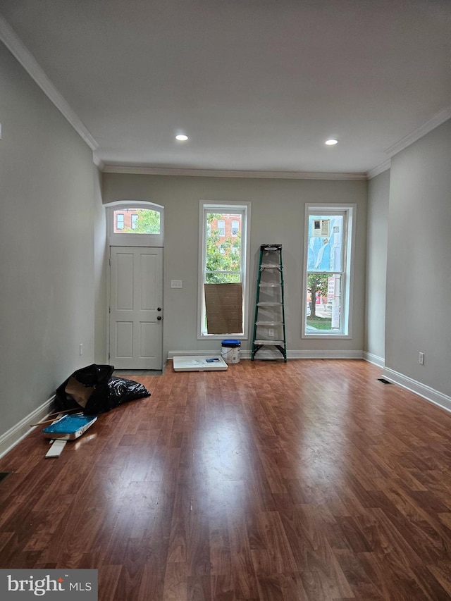 foyer featuring dark hardwood / wood-style floors and crown molding