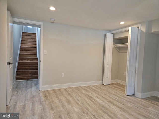 unfurnished bedroom with a closet and light hardwood / wood-style floors