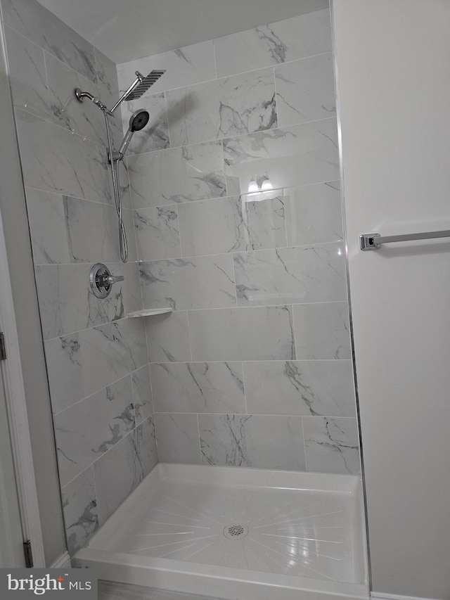 bathroom with tiled shower