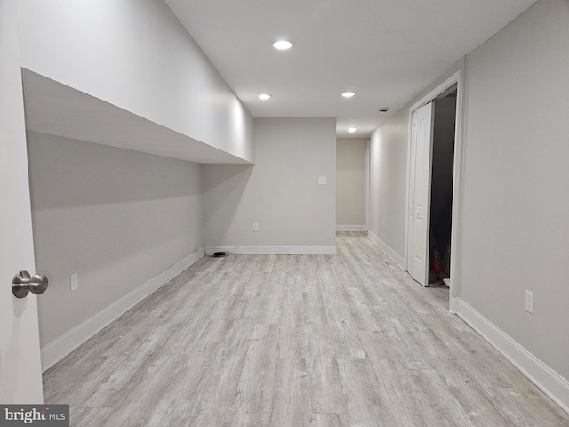 basement with light hardwood / wood-style floors