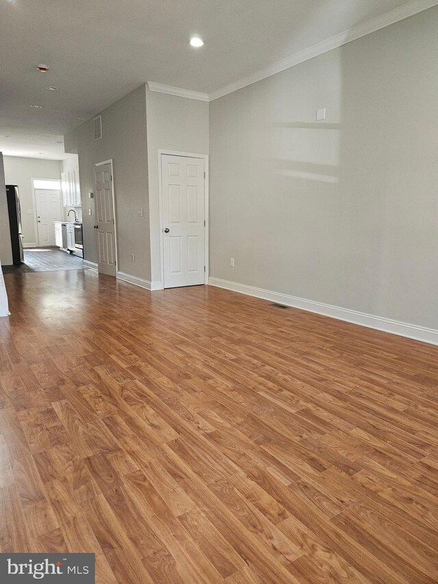 details with white cabinets, dark hardwood / wood-style flooring, and stainless steel refrigerator