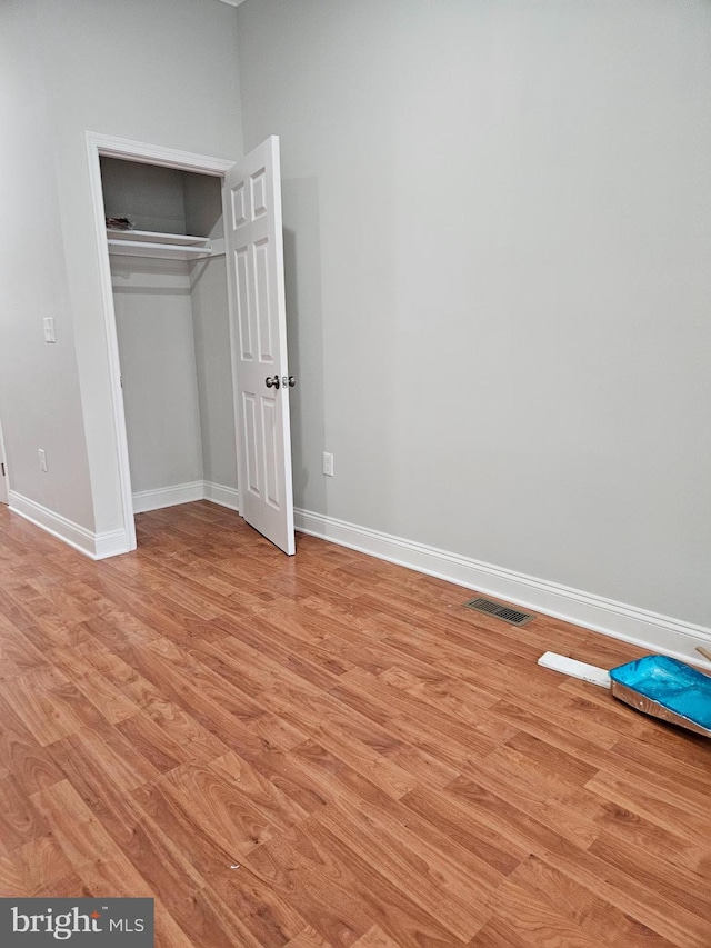 unfurnished bedroom featuring a closet and light hardwood / wood-style flooring