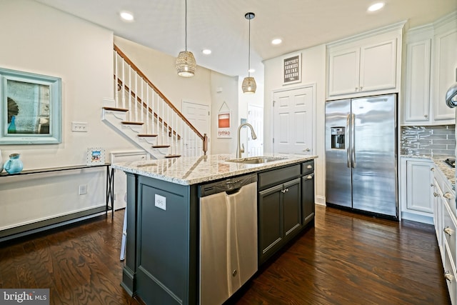 kitchen featuring dark hardwood / wood-style flooring, an island with sink, stainless steel appliances, sink, and white cabinetry